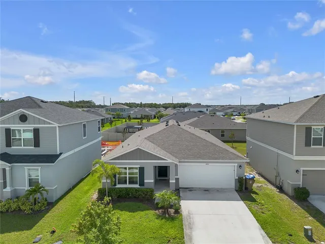an aerial view of a house with a yard