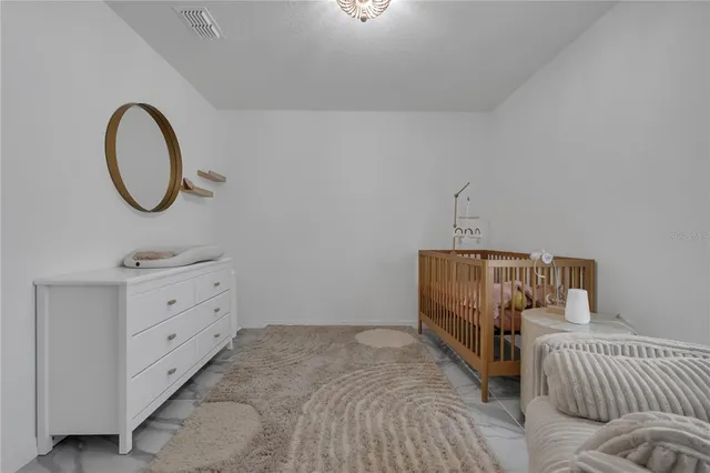 a bedroom with a bed and a dresser