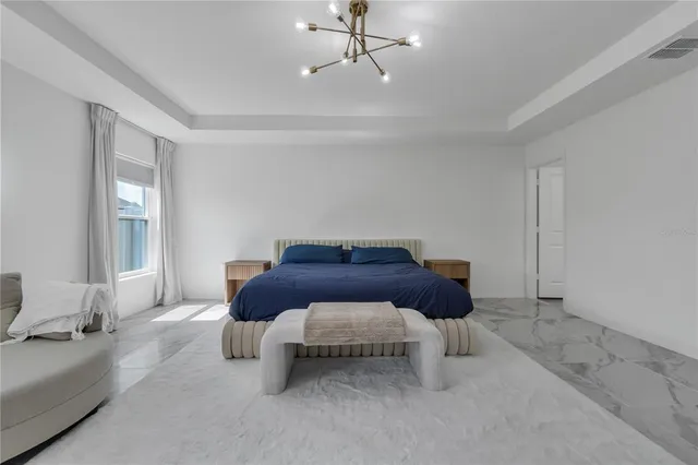 a spacious bedroom with a bed and window