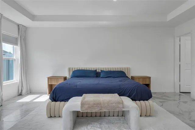 a bedroom with a bed and window