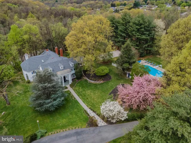 an aerial view of a house with a yard and lake view