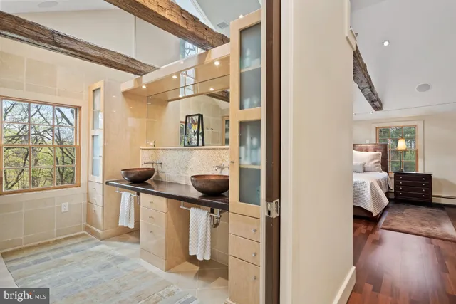 a bedroom with a bed and a refrigerator