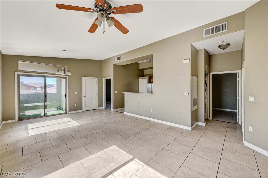 8985 South Durango Drive, Unit 2187 Las Vegas, NV 89113 - Photo 29 of 73 A spacious living area features tile flooring and convenient access to the outdoor patio.