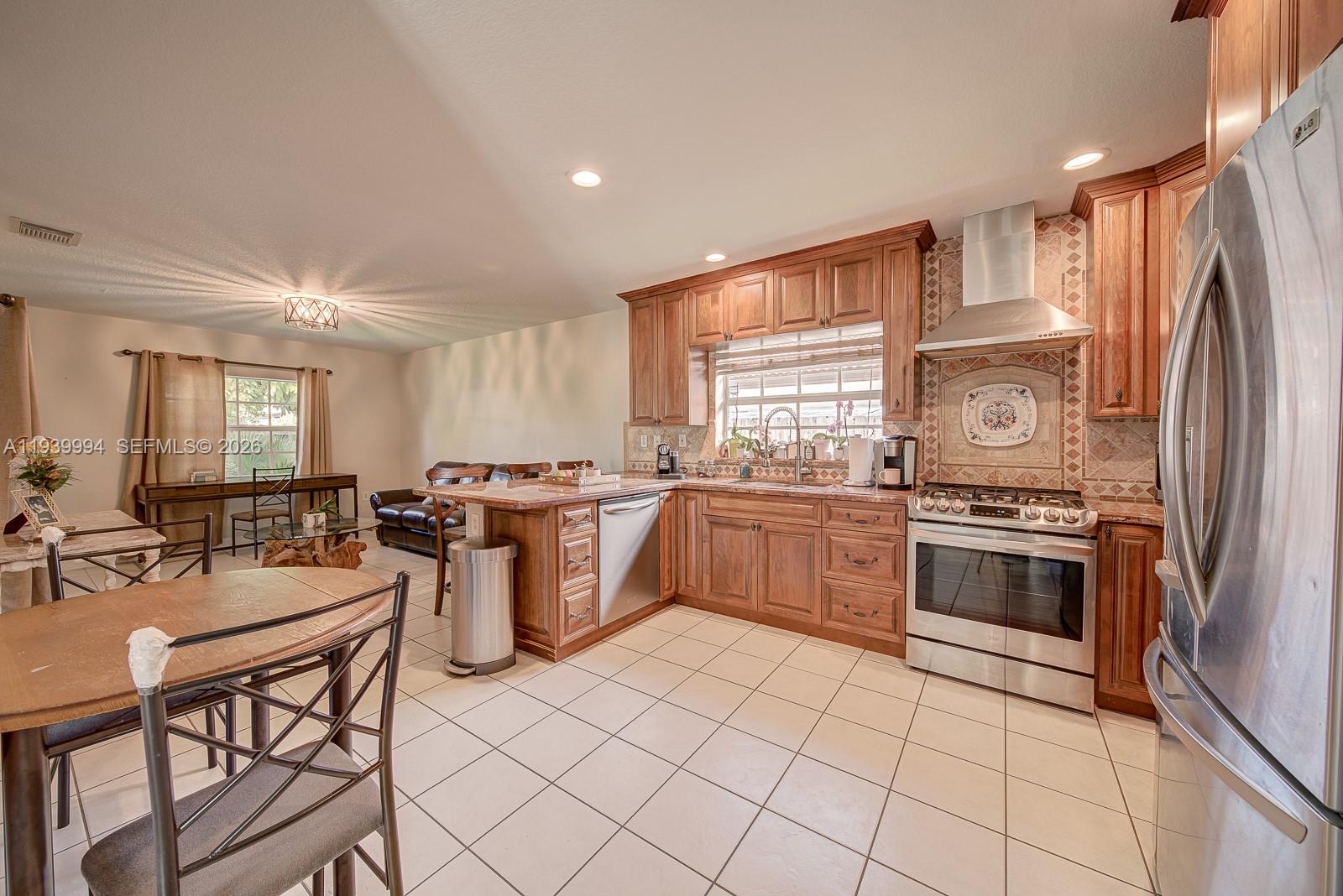 18128 Southwest 151st Avenue Miami, FL 33187 - Photo 21 of 40 a kitchen with a sink appliances cabinets and a counter top space