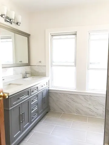 a bathroom with a sink double vanity and a mirror