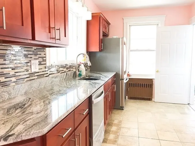 a kitchen with granite countertop a sink and a stove