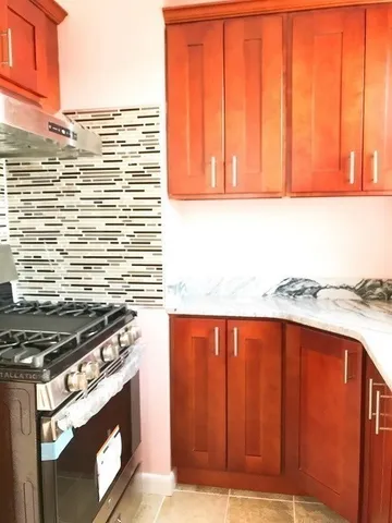 a kitchen with a stove and a window