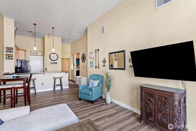 a view of a kitchen with fridge and windows