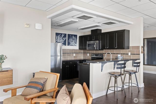 a view of kitchen with furniture and refrigerator