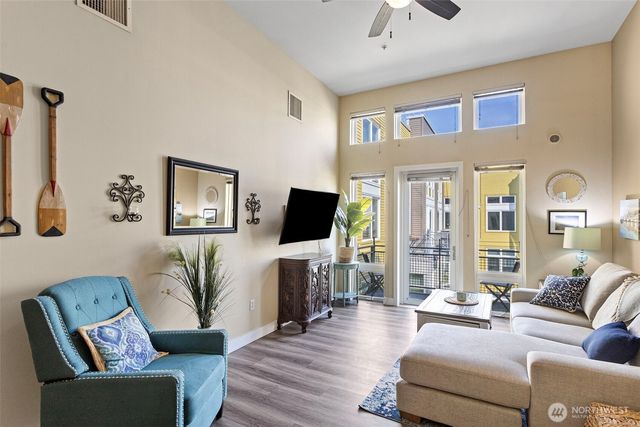 a living room with furniture kitchen view and a dining table