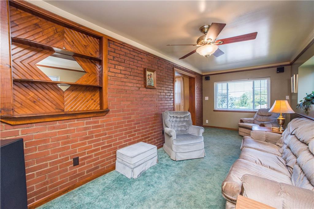 740 Agnew Road Pittsburgh, PA 15227 - Photo 13 of 25 Family room with brick wall and custom wood shelves.