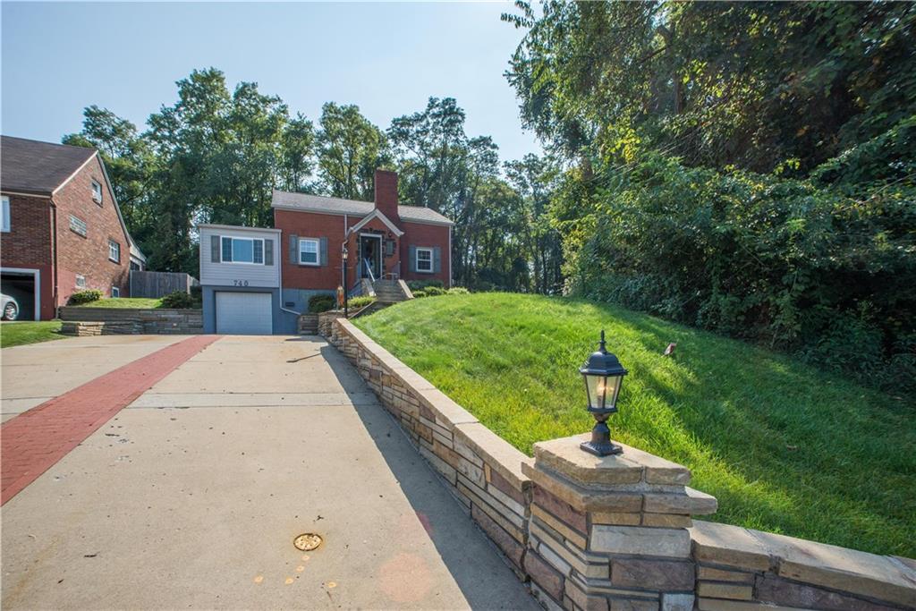 740 Agnew Road Pittsburgh, PA 15227 - Photo 3 of 25 The double wide drive way with lantern and lamp post compliment the stone wall.