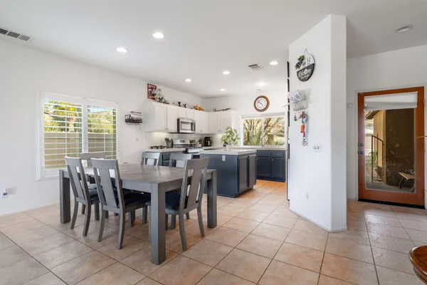 a living room with furniture kitchen view and a dining table