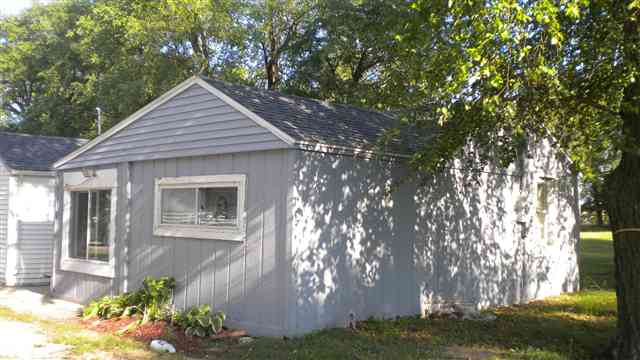 7369-7379 Riverview Road Thomson, IL 61285 - Photo 1 of 5 a front view of a house with garden