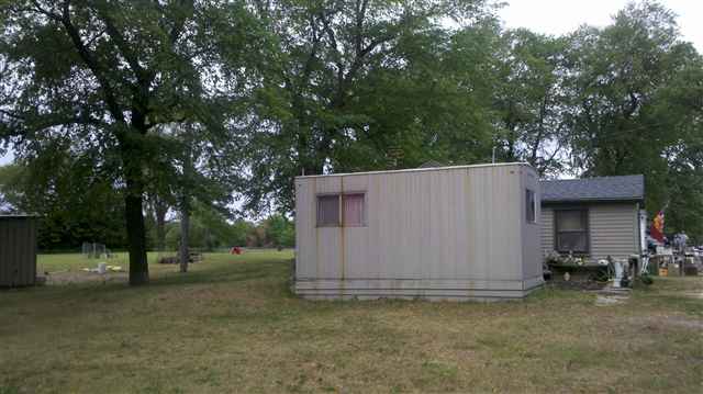 7369-7379 Riverview Road Thomson, IL 61285 - Photo 3 of 5 a view of a barn in the middle of a yard