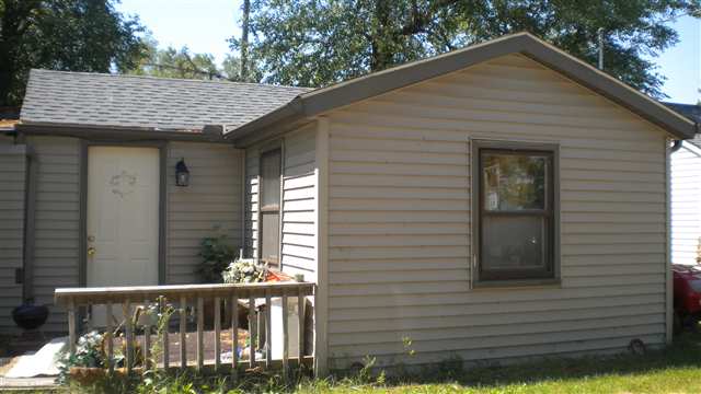 7369-7379 Riverview Road Thomson, IL 61285 - Photo 4 of 5 a view of a wooden house with a yard