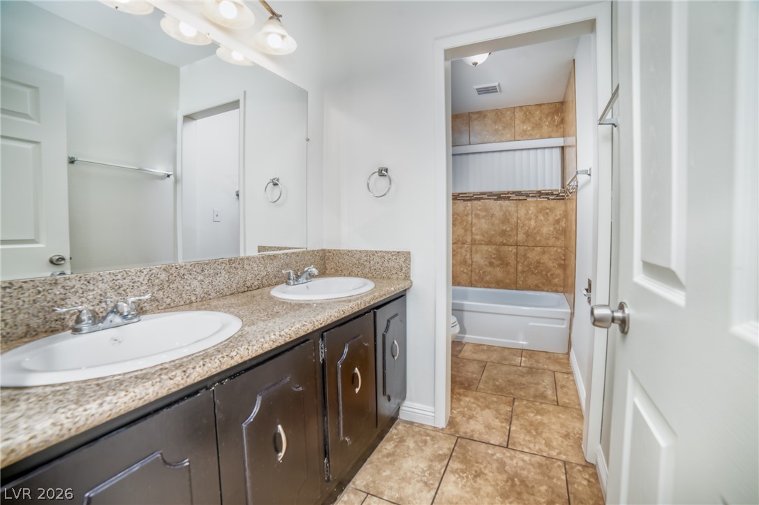 3556 Ruth Drive Las Vegas, NV 89121 - Photo 15 of 21 Granite counters and dual sinks define this well-appointed bathroom vanity.
