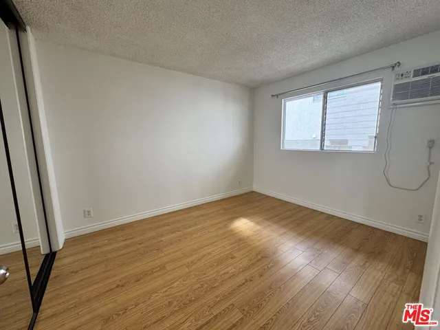 a view of a room with wooden floor and windows