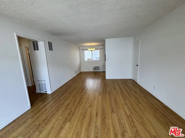 a view of a room with wooden floor and staircase