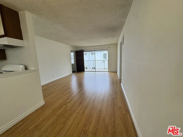 a view of a room with wooden floor and sink