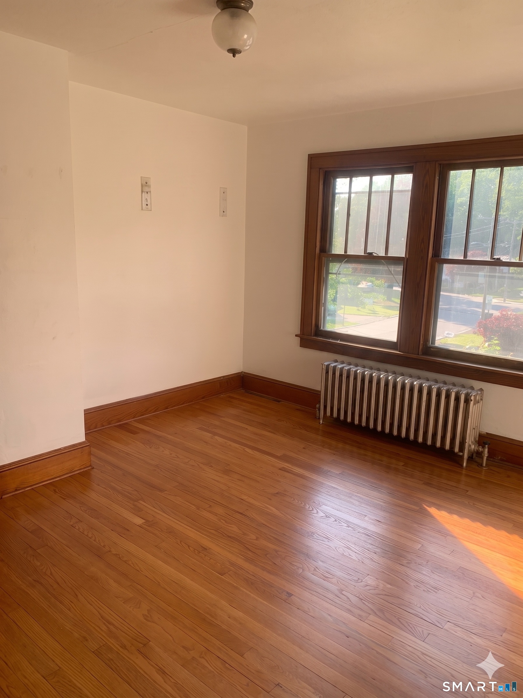 44 Bird Street Torrington, CT 06790 - Photo 8 of 17 wooden floor in an empty room with a window