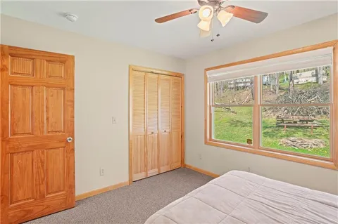 a view of a bedroom with wooden floor