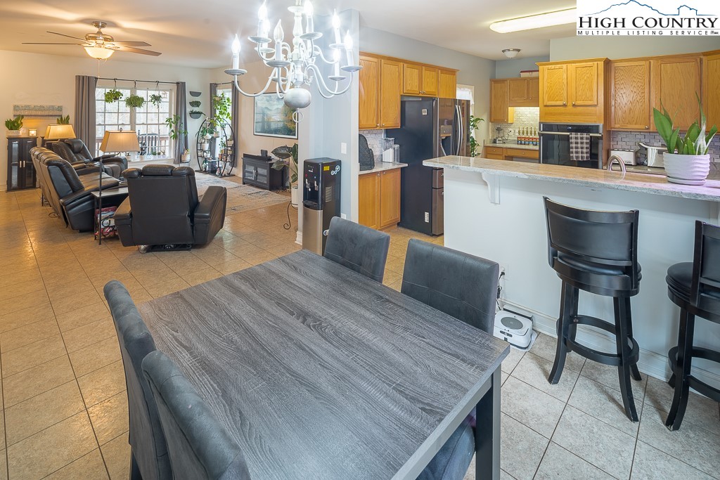 778 Roby Poe Road Crumpler, NC 28617 - Photo 11 of 50 a kitchen with furniture wooden floor and a large window