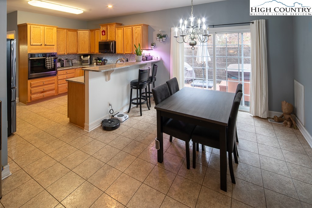778 Roby Poe Road Crumpler, NC 28617 - Photo 12 of 50 a kitchen with stainless steel appliances granite countertop a stove top oven a sink a counter space and cabinets