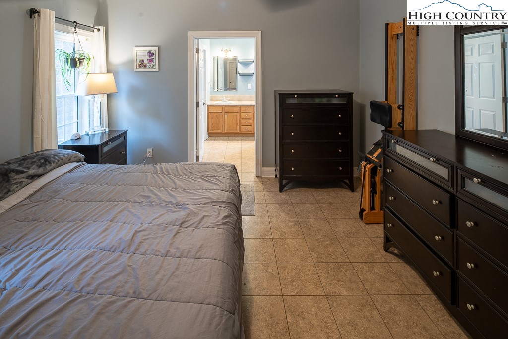 778 Roby Poe Road Crumpler, NC 28617 - Photo 23 of 50 a bedroom with a bed and a dresser