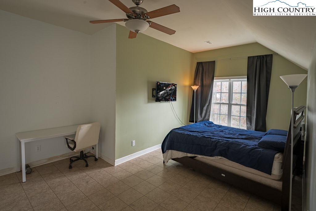 778 Roby Poe Road Crumpler, NC 28617 - Photo 31 of 50 a bedroom with a bed and a window