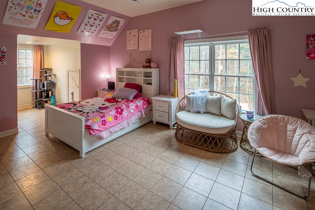 778 Roby Poe Road Crumpler, NC 28617 - Photo 34 of 50 a bedroom with a bed and a couch