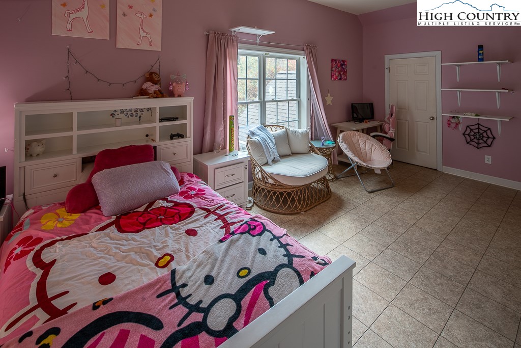 778 Roby Poe Road Crumpler, NC 28617 - Photo 36 of 50 a bedroom with a bed and a window