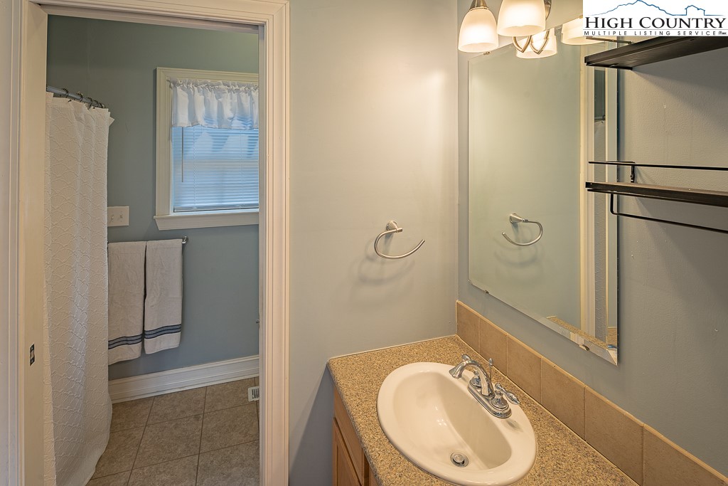 778 Roby Poe Road Crumpler, NC 28617 - Photo 40 of 50 a bathroom with a granite countertop sink toilet and shower