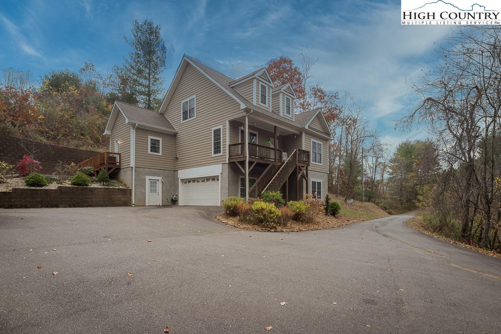 778 Roby Poe Road Crumpler, NC 28617 - Photo 4 of 50 a view of a house with a yard and large tree