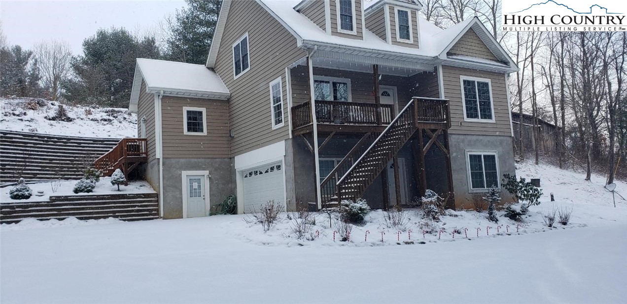 778 Roby Poe Road Crumpler, NC 28617 - Photo 48 of 50 a view of a house with a yard covered in snow
