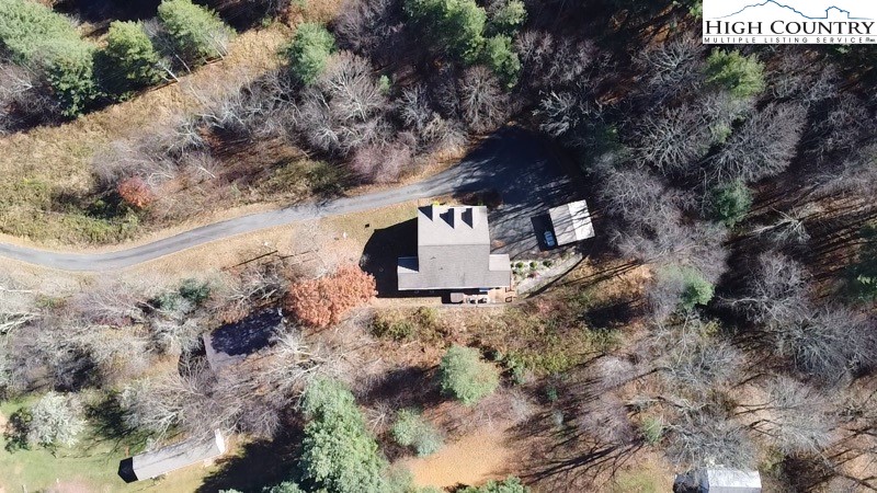 778 Roby Poe Road Crumpler, NC 28617 - Photo 49 of 50 a view of a wooden house with a yard