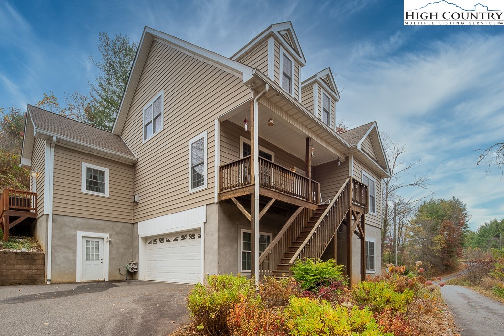 778 Roby Poe Road Crumpler, NC 28617 - Photo 5 of 50 a view of a house with wooden fence and potted plants
