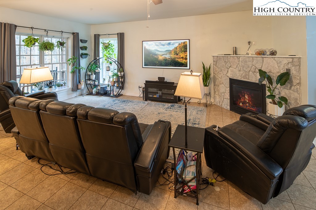 778 Roby Poe Road Crumpler, NC 28617 - Photo 7 of 50 a living room with furniture a flat screen tv and a fireplace