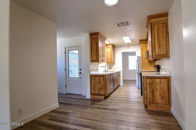 a kitchen with a refrigerator and a sink