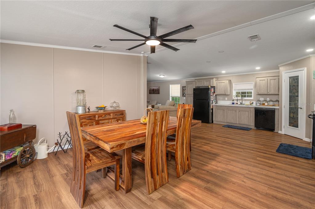15079 Brahma Road Polk City, FL 33868 - Photo 15 of 40 a view of a dining room with furniture and wooden floor