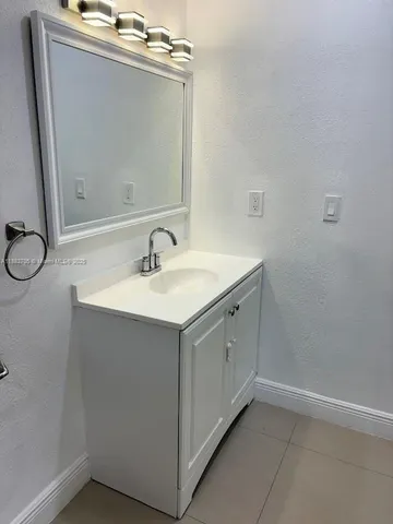 a bathroom with a sink and mirror