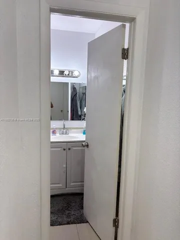 a white toilet sitting next to a bathroom sink