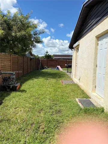 a view of backyard with deck and seating space