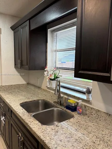 a kitchen with a sink and a window