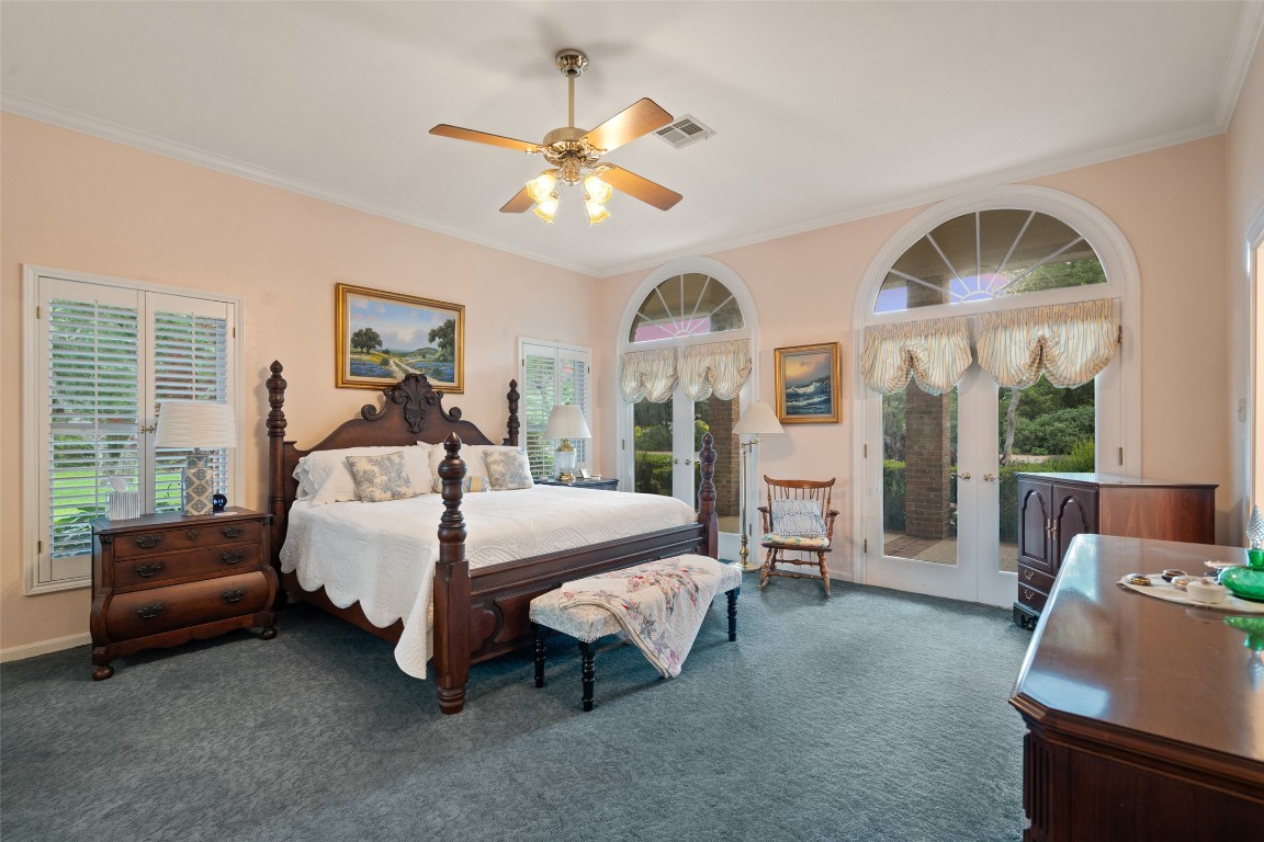 12 Hedge Lane Austin, TX 78746 - Photo 17 of 30 a bed room with a bed and a chandelier