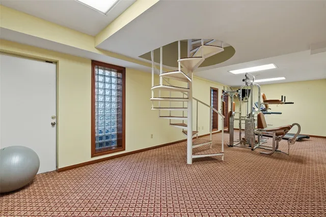 a view of a livingroom with stairs and furniture