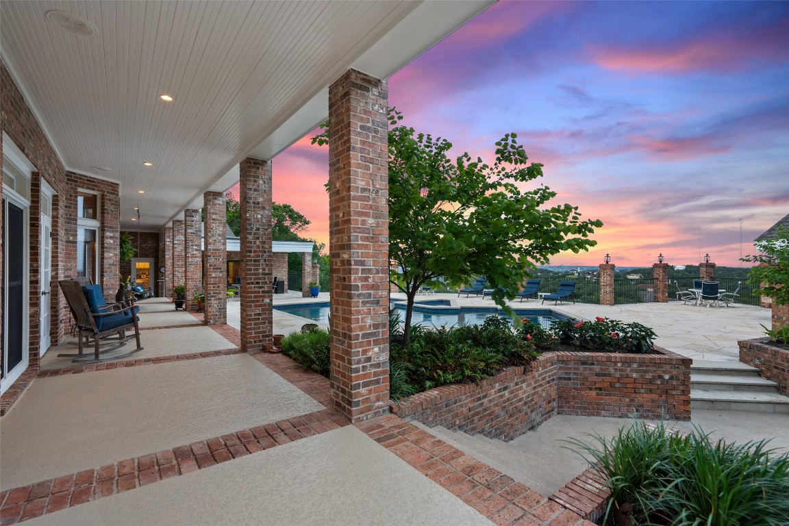 12 Hedge Lane Austin, TX 78746 - Photo 25 of 30 a view of a patio with couches and table and chairs and potted plants
