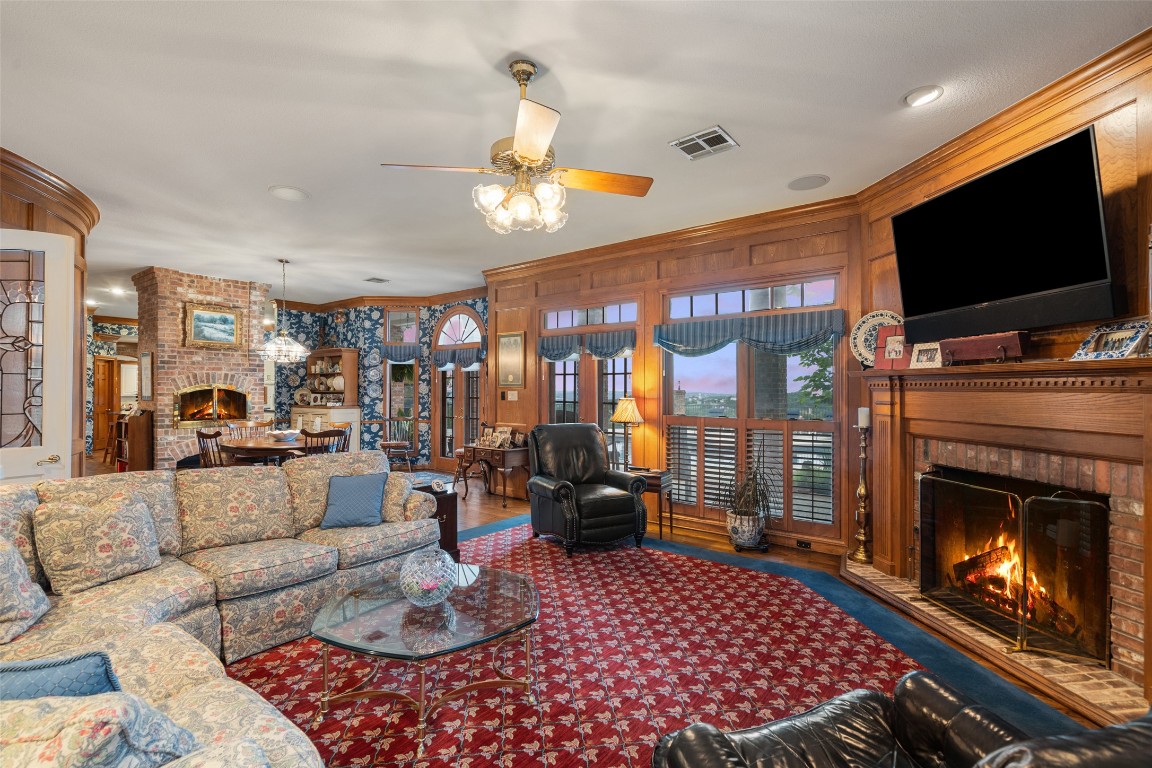 12 Hedge Lane Austin, TX 78746 - Photo 7 of 30 a living room with furniture a flat screen tv and a fireplace