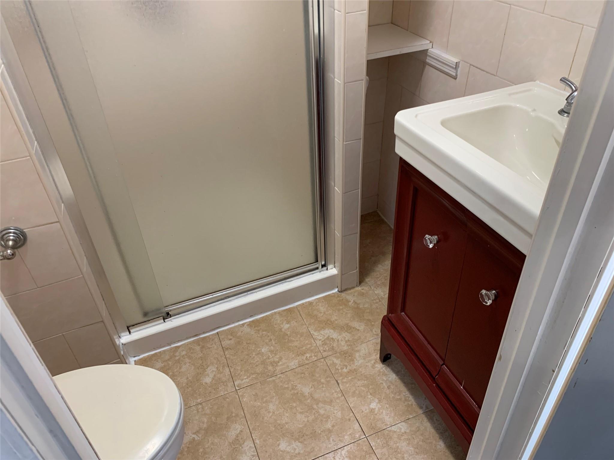 87-33 Commonwealth Boulevard Queens, NY 11426 - Photo 12 of 28 a bathroom with a sink and toilet