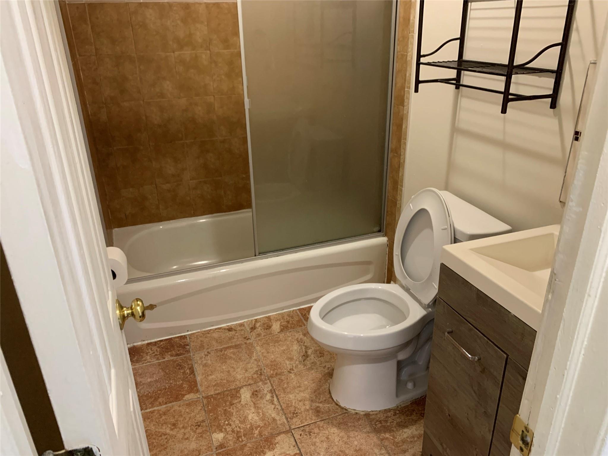 87-33 Commonwealth Boulevard Queens, NY 11426 - Photo 16 of 28 a bathroom with a toilet and a shower